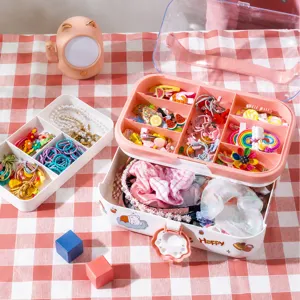 Pink multi-layer kids hair accessory storage box with drawers and clear lid for clips.