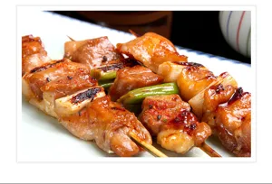 Close-up detail view of wooden bamboo skewers used for BBQ grilling, tasty food presentation.