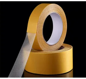 Close-up detail of high-viscosity double-sided cloth mesh tape for strong carpet fixing.