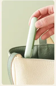 Portable mini threader and seam ripper tool for home sewing, detailed close-up view.