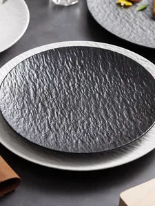 Textured ceramic steak plate, black and white round dinner dish for home kitchen dining.