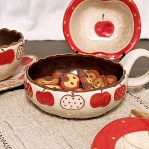 Detailed view of retro ceramic bowl and plate set with cute apple pattern for home kitchen use.