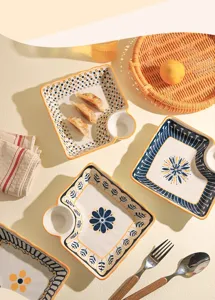 Ceramic dumpling plate with dipping saucer sauce compartment partitioned serving dish.