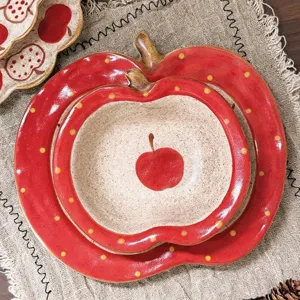 Ceramic apple bowl detail shot, cute retro red polka dot tableware piece for kitchen use.