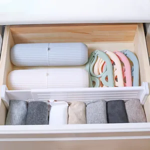 Adjustable plastic drawer divider organizer for wardrobe and home storage neatly organized.