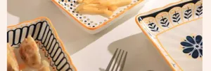 Detailed view of ceramic tableware plates showcasing exquisite blue and white patterns and orange edges.