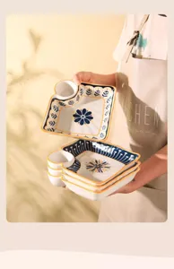 Ceramic dumpling plate with sauce dish, compartment tray, blue floral design, kitchen tool.