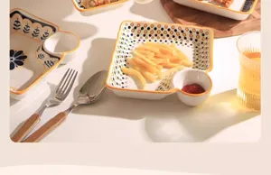 Ceramic partitioned snack plate with dipping sauce compartment, stylish kitchen tableware detail.