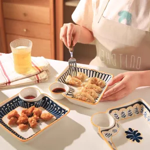Ceramic dumpling plate with sauce compartment, stylish partitioned tableware for breakfast and food.