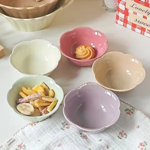 Close-up of cute ceramic flower-shaped dipping bowls in pastel colors, perfect for snacks.