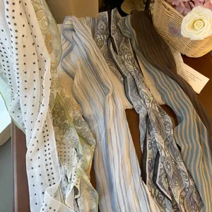 Close-up of elegant French country style chiffon scarves and fabric neckwear details.