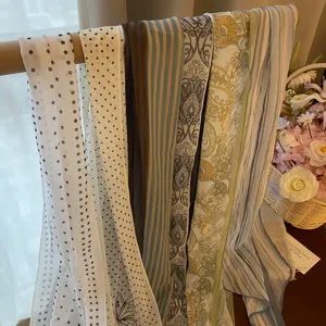 Assorted patterned chiffon scarves featuring polka dots, stripes, and paisley designs.