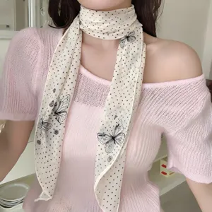 French vintage polka dot butterfly chiffon scarf detail shot, elegant neck accessory for women.
