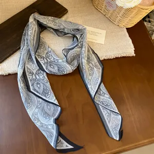 Chic blue and white printed chiffon ribbon scarf, elegant paisley pattern detail accessory.