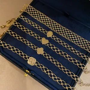 Detailed view of vintage gold mesh chain bracelets set with elegant pendants for women.