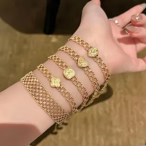 Vintage gold mesh chain bracelet set with heart and clover charms detail shot view