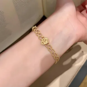 Vintage gold-tone multi-strand beaded mesh bracelet with intricate heart pendant detail.
