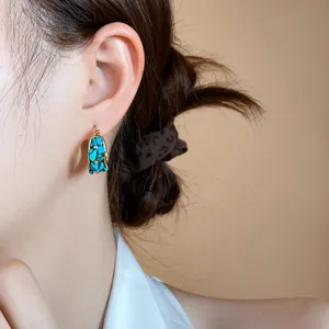 Vintage French style blue stone inlaid gold hoop earrings, elegant retro jewelry accessory.
