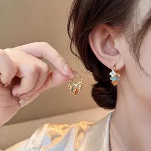 Vintage gold-plated blue and orange stone clover tassel hoop earrings for women elegance.
