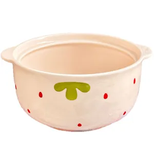 Cute ceramic soup bowl with dual handles and strawberry pattern for delicious home noodle meals.