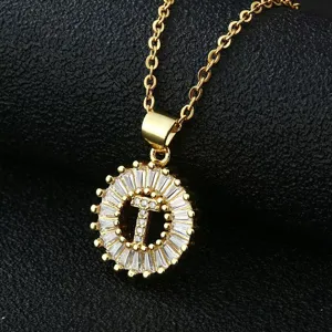 Gold-plated copper letter T pendant necklace with sparkling cubic zirconia halo design.