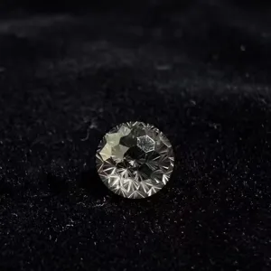 Detailed close-up of exquisite round faceted gemstone showcasing brilliant fire and refraction.