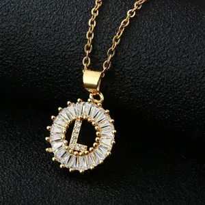 Gold-plated letter L pendant necklace with sparkling cubic zirconia baguette stones detail.