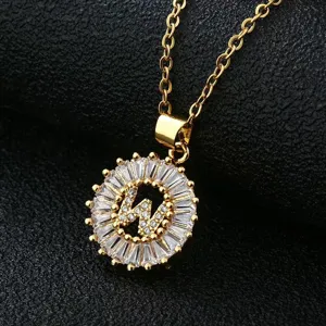 Close-up detail of a gold-plated letter W pendant necklace sparkling with zircon crystals.