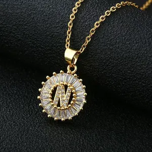 Detailed close-up of a gold-plated copper alphabet N pendant necklace with sparkling cubic zirconia.