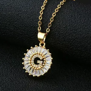 Close-up detail of the gold-plated letter G pendant necklace with sparkling cubic zirconia.