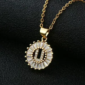Gold-plated letter U pendant necklace with sparkling cubic zirconia in a circular design.