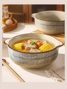 Close-up of Japanese retro ceramic soup bowl with binaural handles and blue striped pattern design.