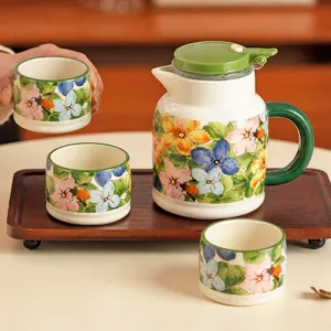 Elegant ceramic water set with floral bee pattern pitcher, cups and wooden tray for home.