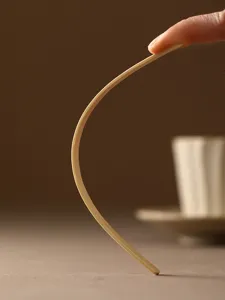 Flexible bamboo coffee stirrer close-up showing bendable material design texture details