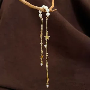 Detailed close-up of exquisite pearl and star tassel ear cuff featuring elegant hanging chains.