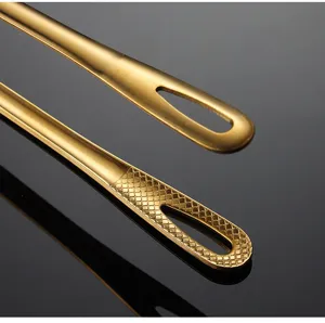 Gold stainless steel kitchen food tong detail view showing hanging hole and pattern.