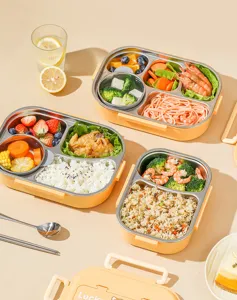 Roestvrijstalen lunchbox met meerdere vakken en gele schil voor dagelijkse maaltijden.
