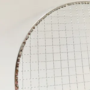 Detailed view of a portable round BBQ grill net, sturdy metal mesh for outdoor cooking and tea.