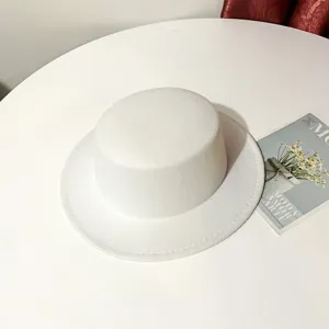 White wool flat top hat detail shot, showing exquisite felt texture, elegant accessory.