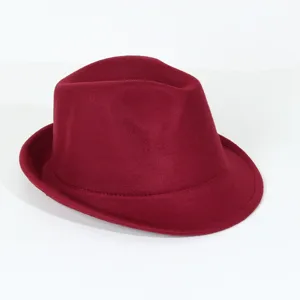 Wine red felt fedora hat detail, vintage short brim jazz hat close up shot showing fine texture.