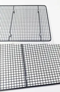Black metal wire baking cooling rack detail view, rectangular bread cooling grid.