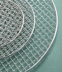 Stainless steel round BBQ grill mesh detail, nested wire grates for camping and outdoor cooking.