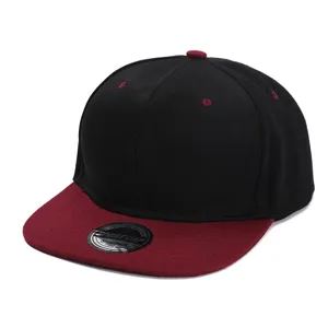 Close-up detail of the black and burgundy snapback hat showing brim sticker and stitching.