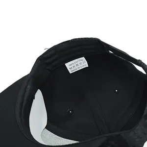 Detailed interior view of the black baseball cap showcasing the cotton wash label.