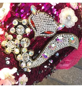 Rhinestone sequin baseball cap detail, sparkling crystals and flower decor, dazzling style.