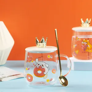 Detailed view of the cute cartoon glass cup with crown lid and golden spoon for breakfast.