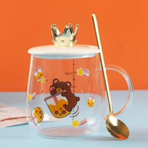Clear heat-resistant glass cup with cute bear print, crown lid, and spoon for drinks.