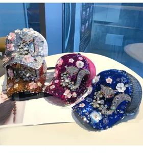 Detailed sparkly sequin baseball caps featuring stylish rhinestone fox and floral appliques.