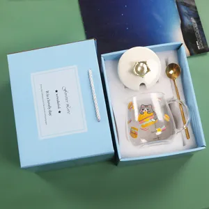 Cute cartoon heat-resistant glass mug set with golden spoon and elegant gift box details.
