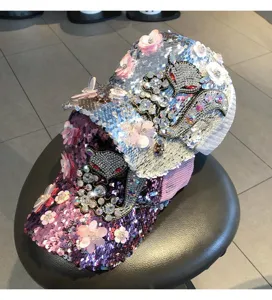 Rhinestone sequin baseball cap detail, sparkling floral and animal rhinestone patches, mesh back.